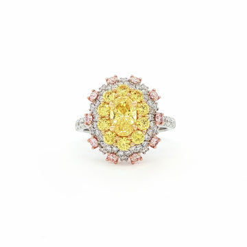 This 18KT Yellow Gold ring showcases a vibrant center of brilliant yellow diamonds, elegantly encircled by a halo of pink and white diamonds. The bold contrasts of colors create a captivating play of light, making it a true statement piece for any occasion.