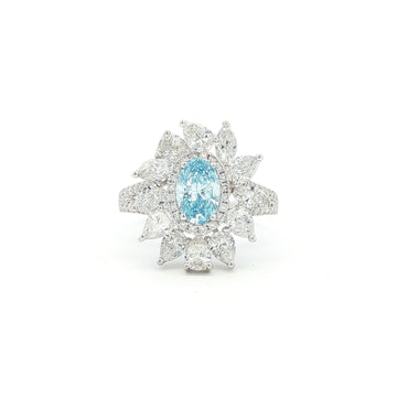 This 18K White Gold Ring showcases an exquisite floral design with a captivating oval-cut blue diamond centre, framed with white diamond "petals". A timeless embodiment of luxury and sophistication, perfect for making a statement!