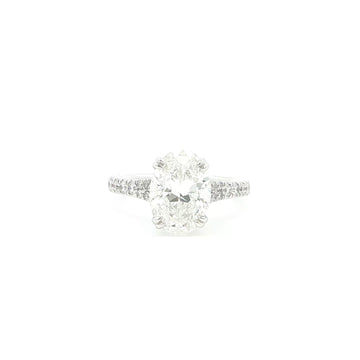 Oval cut lab grown diamond ring with pavé set accent band in 18k white gold.