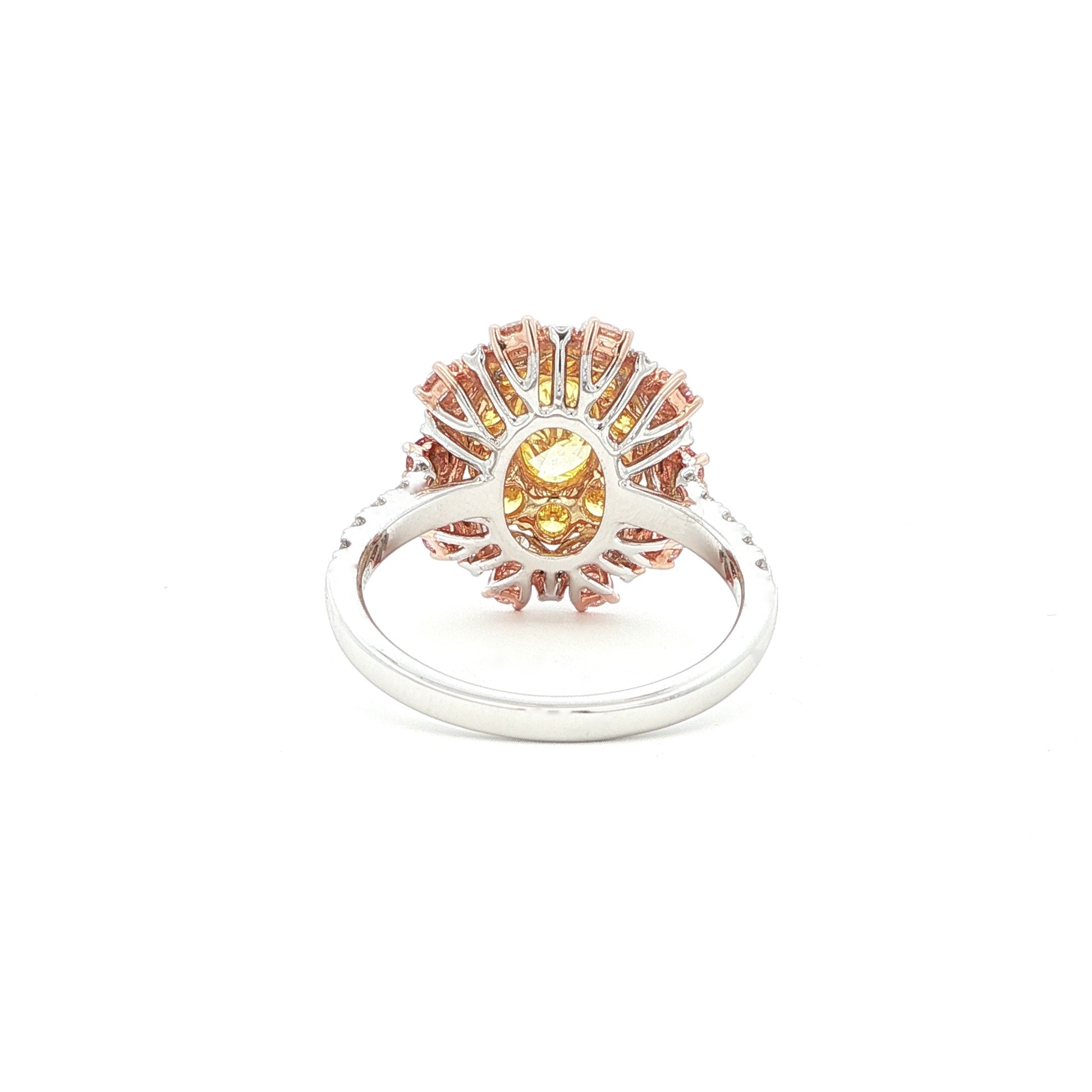 This 18KT Yellow Gold ring showcases a vibrant center of brilliant yellow diamonds, elegantly encircled by a halo of pink and white diamonds. The bold contrasts of colors create a captivating play of light, making it a true statement piece for any occasion.