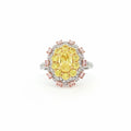 This 18KT Yellow Gold ring showcases a vibrant center of brilliant yellow diamonds, elegantly encircled by a halo of pink and white diamonds. The bold contrasts of colors create a captivating play of light, making it a true statement piece for any occasion.