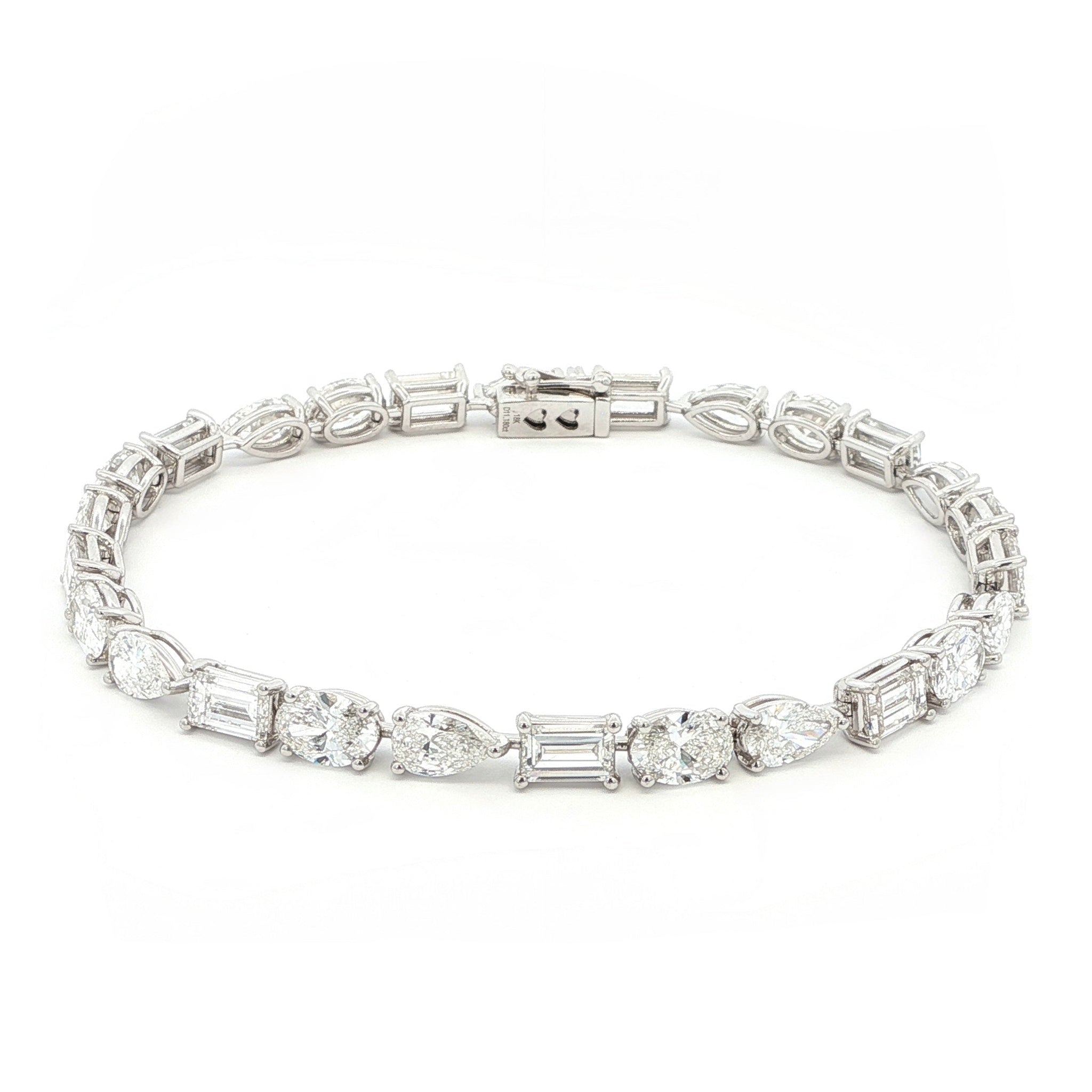 18K White Gold, Fancy Shape, Baguette, Pear, and Oval-Cut Tennis Bracelet 

Crafted in 18K White Gold, this exquisite tennis bracelet showcases an alternating pattern of Baguette, Pear, and Oval-Cut Lab-Grown Diamonds. Meticulous craftsmanship shines through each prong-set facet, delivering a rhythmic, multidimensional sparkle from every angle. This modern blend of three shapes creates a timeless yet contemporary elegance, perfect for elevating moments that deserve to shine. 