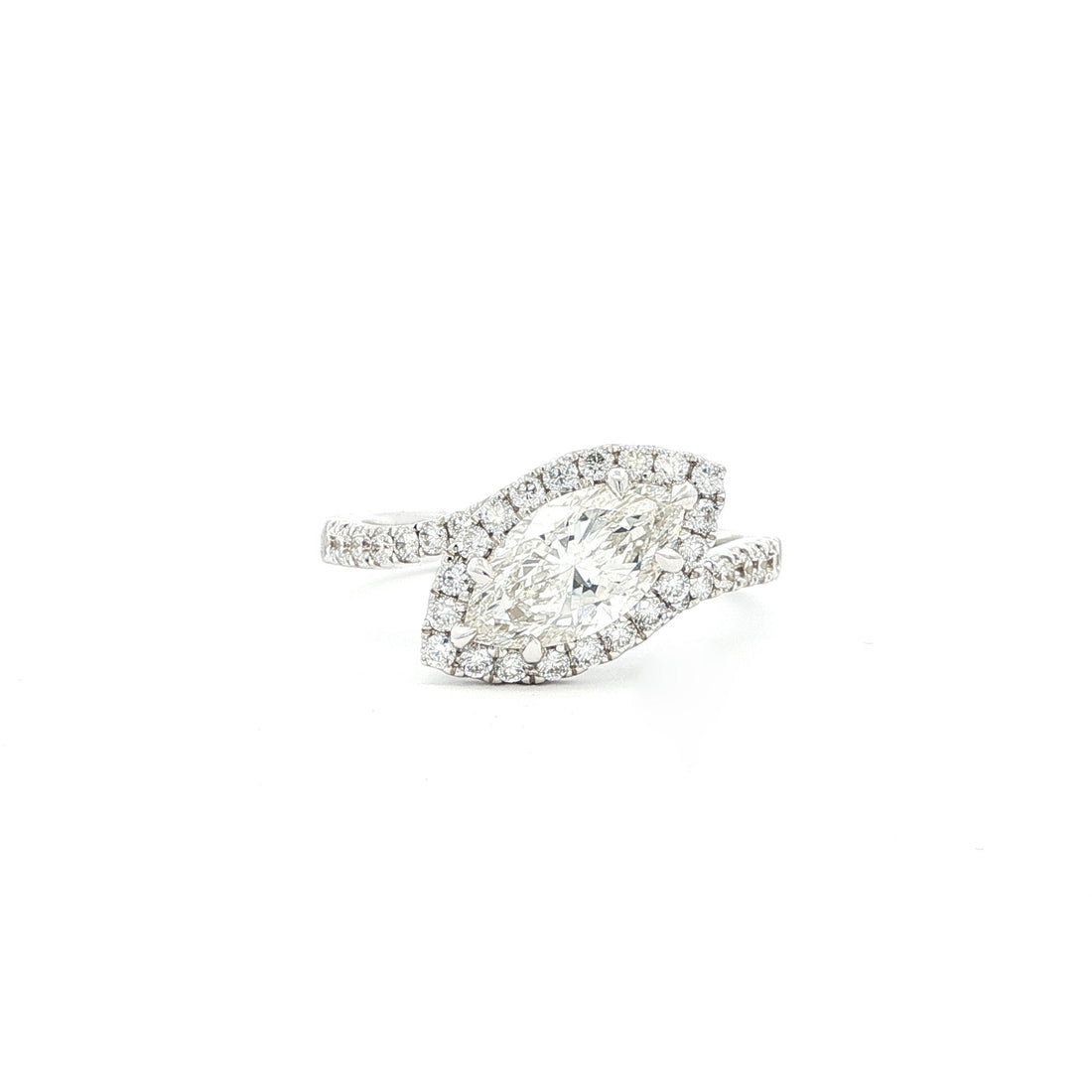 This 18K White Gold features a Marquise centre with a perfectly studded halo. The band enhances the centre diamond, creating an unforgettable piece!&nbsp;