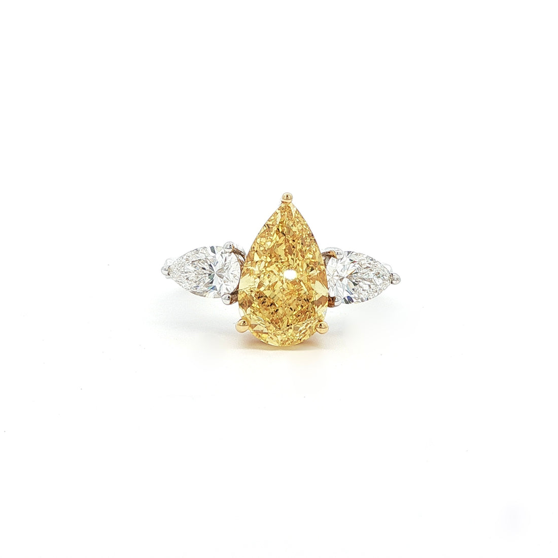 This 18K White Gold ring features a fancy yellow pear-cut diamond at its centre, framed by two pear-cut side stones. Perfect for special occasions or as a statement piece in your everyday jewelry collection!