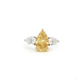This 18K White Gold ring features a fancy yellow pear-cut diamond at its centre, framed by two pear-cut side stones. Perfect for special occasions or as a statement piece in your everyday jewelry collection!