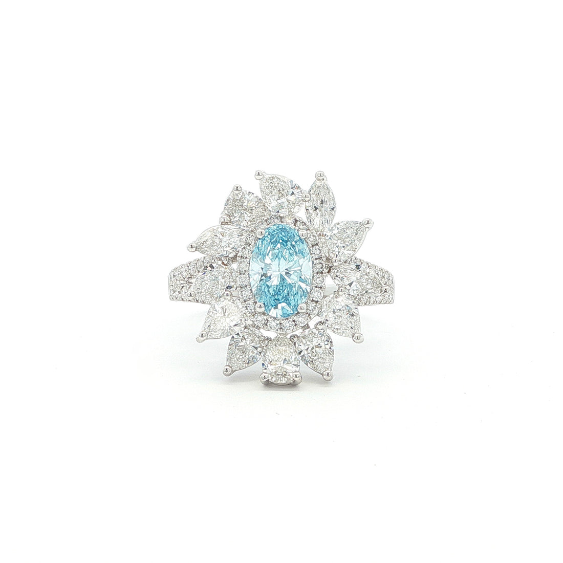 This 18K White Gold Ring showcases an exquisite floral design with a captivating oval-cut blue diamond centre, framed with white diamond "petals". A timeless embodiment of luxury and sophistication, perfect for making a statement!