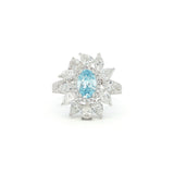 This 18K White Gold Ring showcases an exquisite floral design with a captivating oval-cut blue diamond centre, framed with white diamond "petals". A timeless embodiment of luxury and sophistication, perfect for making a statement!