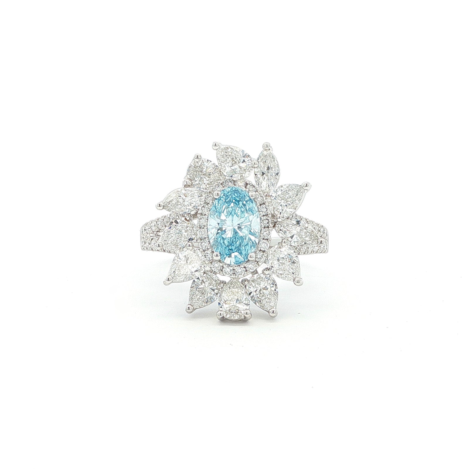 This 18K White Gold Ring showcases an exquisite floral design with a captivating oval-cut blue diamond centre, framed with white diamond "petals". A timeless embodiment of luxury and sophistication, perfect for making a statement!