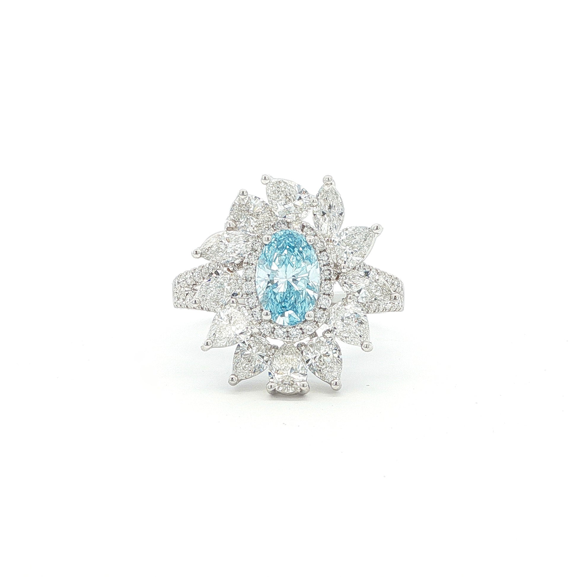 This 18K White Gold Ring showcases an exquisite floral design with a captivating oval-cut blue diamond centre, framed with white diamond "petals". A timeless embodiment of luxury and sophistication, perfect for making a statement!