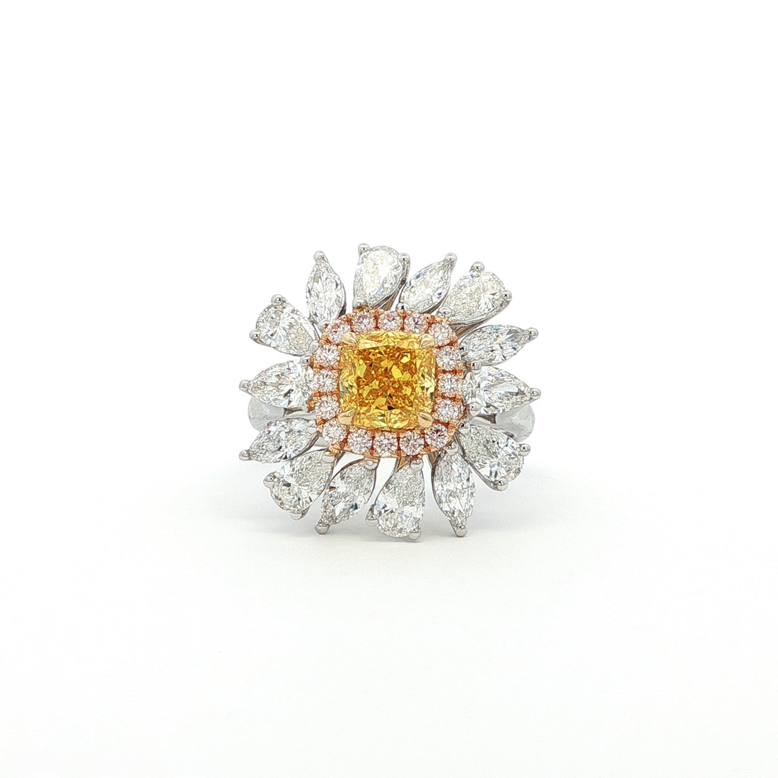 The sunflower-inspired Lumine ring is crafted in 18K tri-color gold (White, Yellow, and Rose Gold). At the centre is a fancy yellow cushion-cut diamond set in Yellow Gold. Surrounding it is a halo of pink diamonds set in Rose Gold. Completing the bloom are "petals" of white diamond set in White Gold. The result is a bold and captivating dual-tone statement piece, perfect for adding a touch of glamour to any evening look.