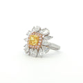 The sunflower-inspired Lumine ring is crafted in 18K tri-color gold (White, Yellow, and Rose Gold). At the centre is a fancy yellow cushion-cut diamond set in Yellow Gold. Surrounding it is a halo of pink diamonds set in Rose Gold. Completing the bloom are 