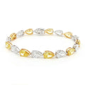 18K White and Yellow Gold Duo-Tone Pear-Cut Lab-Grown Diamond Bracelet

A bold, duo-tone bracelet that showcases Pear-cut diamonds in an alternating pattern of white and yellow stones. Each diamond is securely held in place by a refined three-prong design, with white diamonds set in white gold and yellow stones in yellow gold. Crafted in a sophisticated combination of 18K White and Yellow Gold, this bracelet offers modern luxury for any occasion.