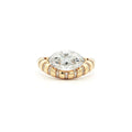This 18K Yellow Gold ring showcases a Marquise centre stone set on a bold band, decorated with sparkling diamonds. Its exquisite craftsmanship and sophisticated design make it the perfect statement piece for any look!