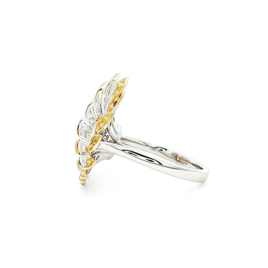 This 18K Yellow Gold ring exudes luxury, showcasing a yellow oval-cut diamond centre with a delicate floral-inspired halo adorned with white and yellow diamonds. The meticulous craftsmanship makes it a standout piece, perfect for adding a touch of glamor to your look!
