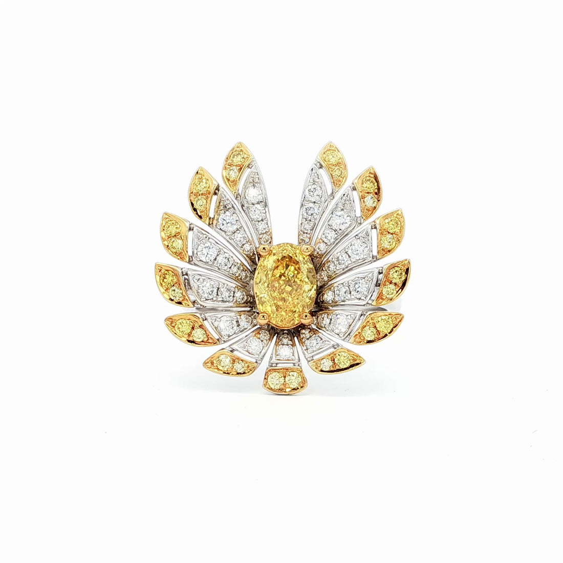 This 18K Yellow Gold ring exudes luxury, showcasing a yellow oval-cut diamond centre with a delicate floral-inspired halo adorned with white and yellow diamonds. The meticulous craftsmanship makes it a standout piece, perfect for adding a touch of glamor to your look!
