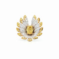 This 18K Yellow Gold ring exudes luxury, showcasing a yellow oval-cut diamond centre with a delicate floral-inspired halo adorned with white and yellow diamonds. The meticulous craftsmanship makes it a standout piece, perfect for adding a touch of glamor to your look!