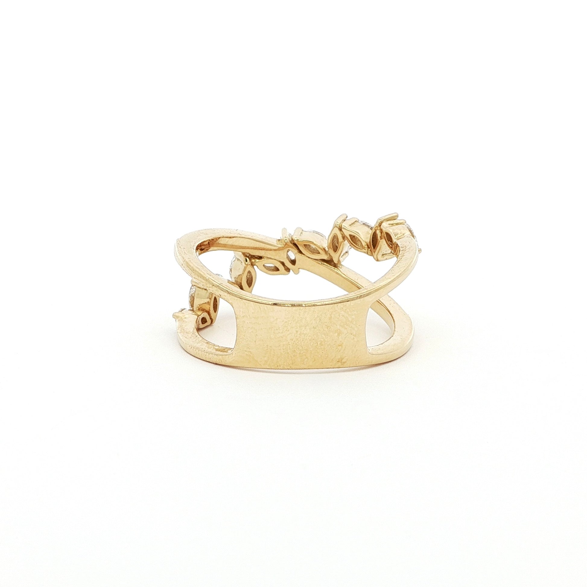 This 18K Yellow Gold ring features a unique cross wrap design adorned with Marquise and Pavé diamonds. The intricate detailing and elegant curves make it a perfect accessory for any occasion, whether it's a formal event or a casual outing.