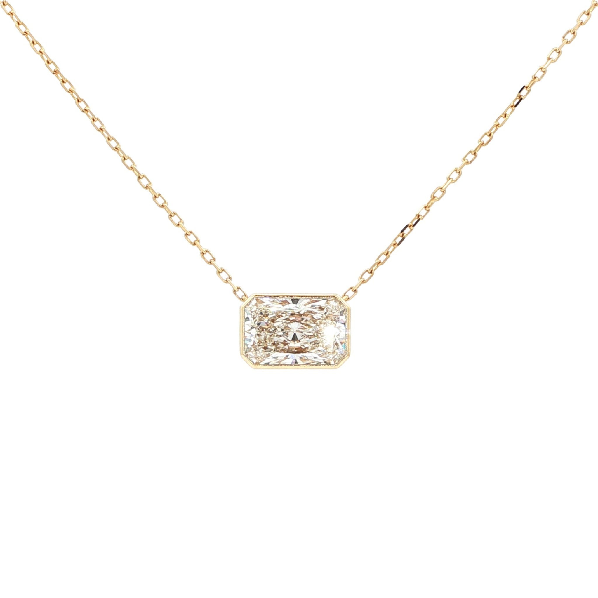 Lab-grown radiant-cut diamond pendant necklace in 18k yellow gold, bezel set. 