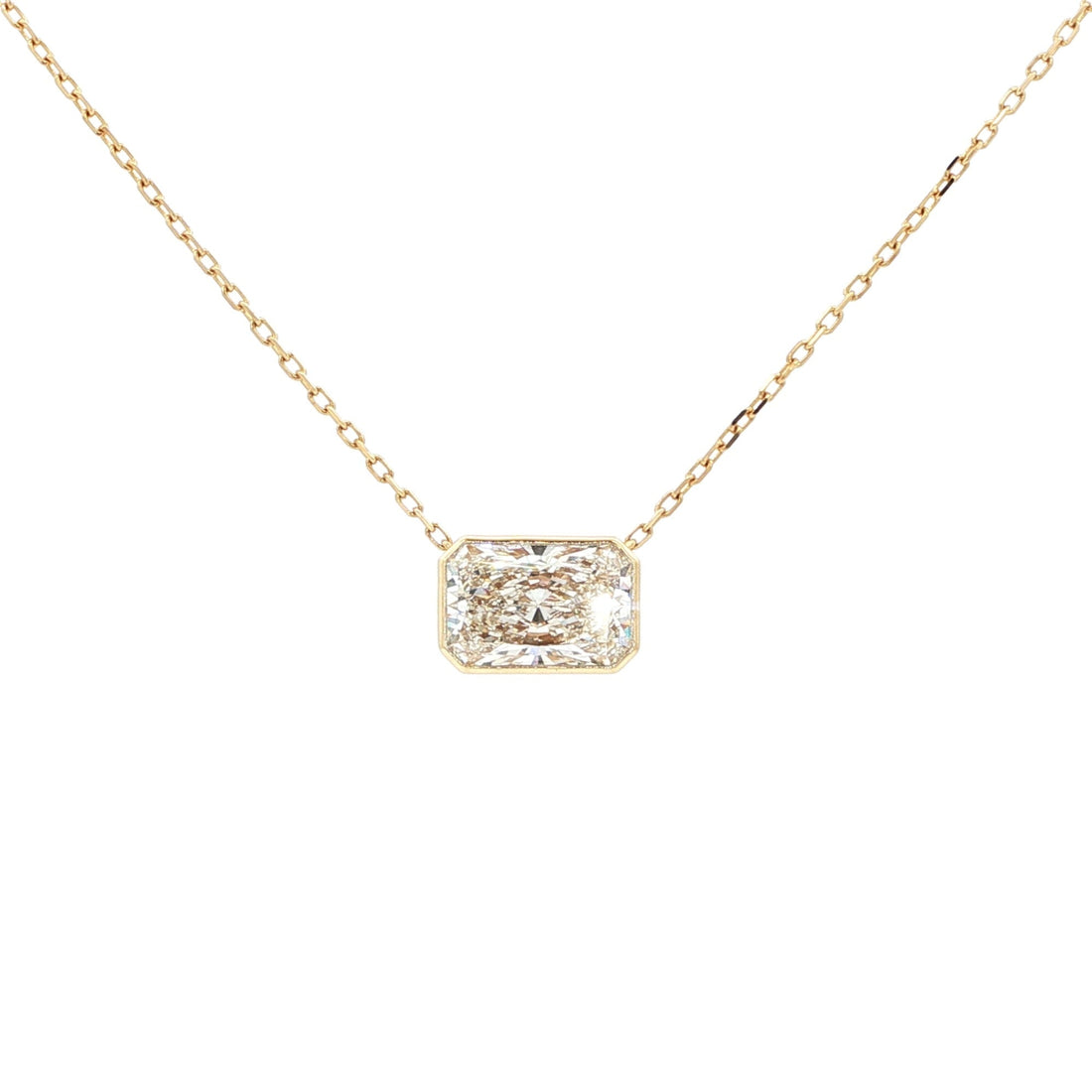 Lab-grown radiant-cut diamond pendant necklace in 18k yellow gold, bezel set. 