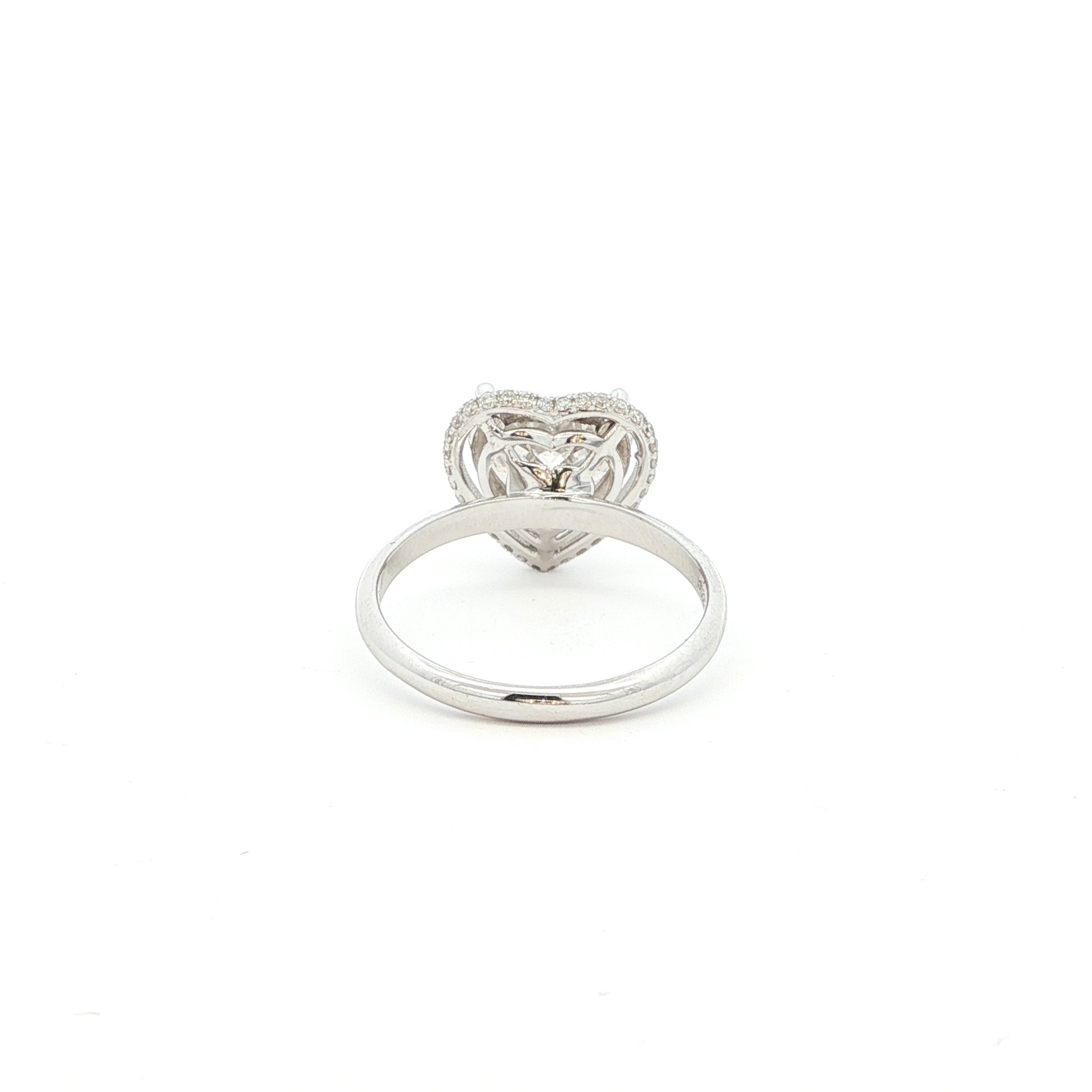 Crafted in 18K White Gold, this ring features a brilliant heart-shaped lab-grown diamond embraced by a glittering halo. Beneath the centre stone, a hidden halo adds an extra tier of light, the double-halo effect creates depth and radiance, making this ring a true statement of elegance.