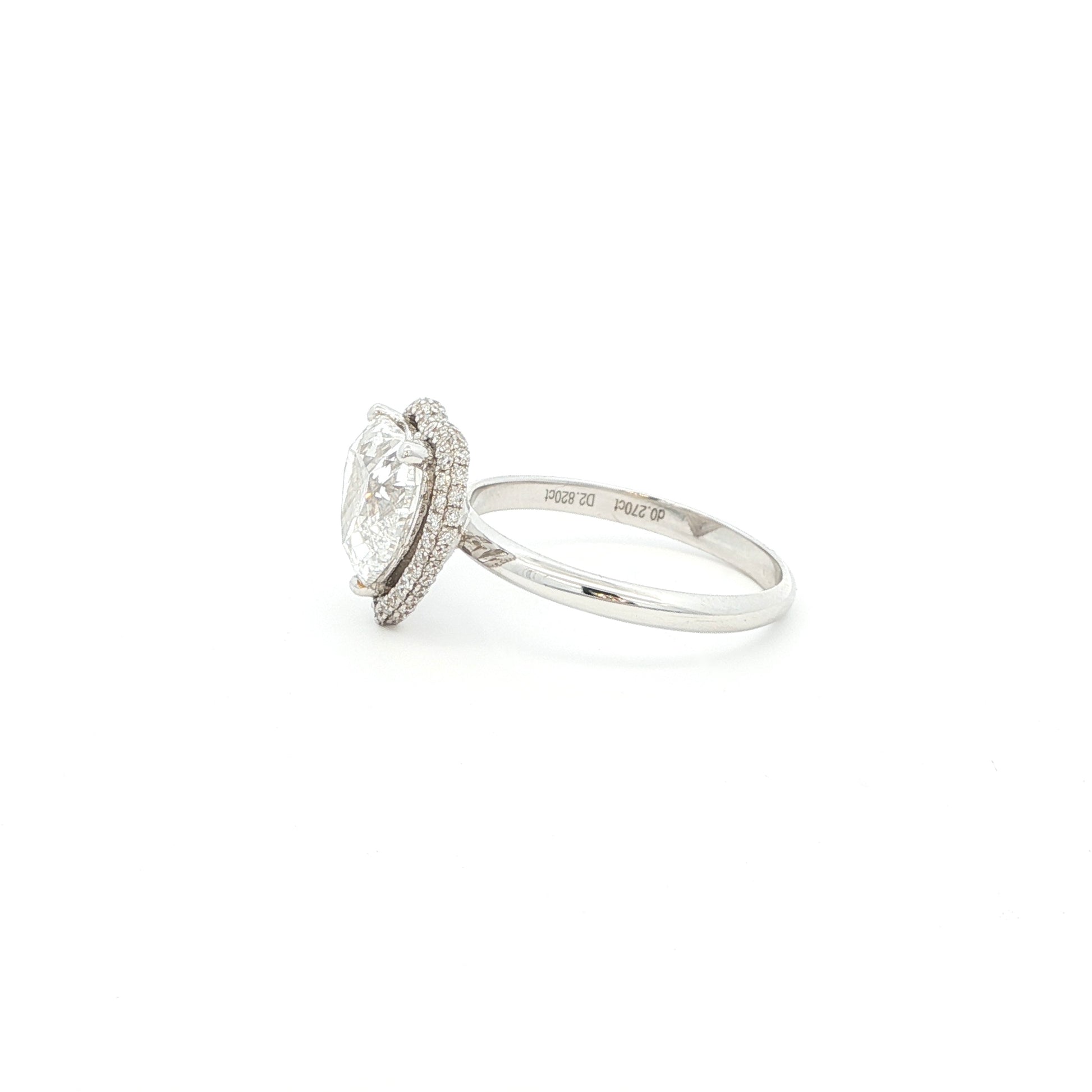 Crafted in 18K White Gold, this ring features a brilliant heart-shaped lab-grown diamond embraced by a glittering halo. Beneath the centre stone, a hidden halo adds an extra tier of light, the double-halo effect creates depth and radiance, making this ring a true statement of elegance.
