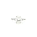Oval cut lab grown diamond ring with pavé set accent band in 18k white gold. 