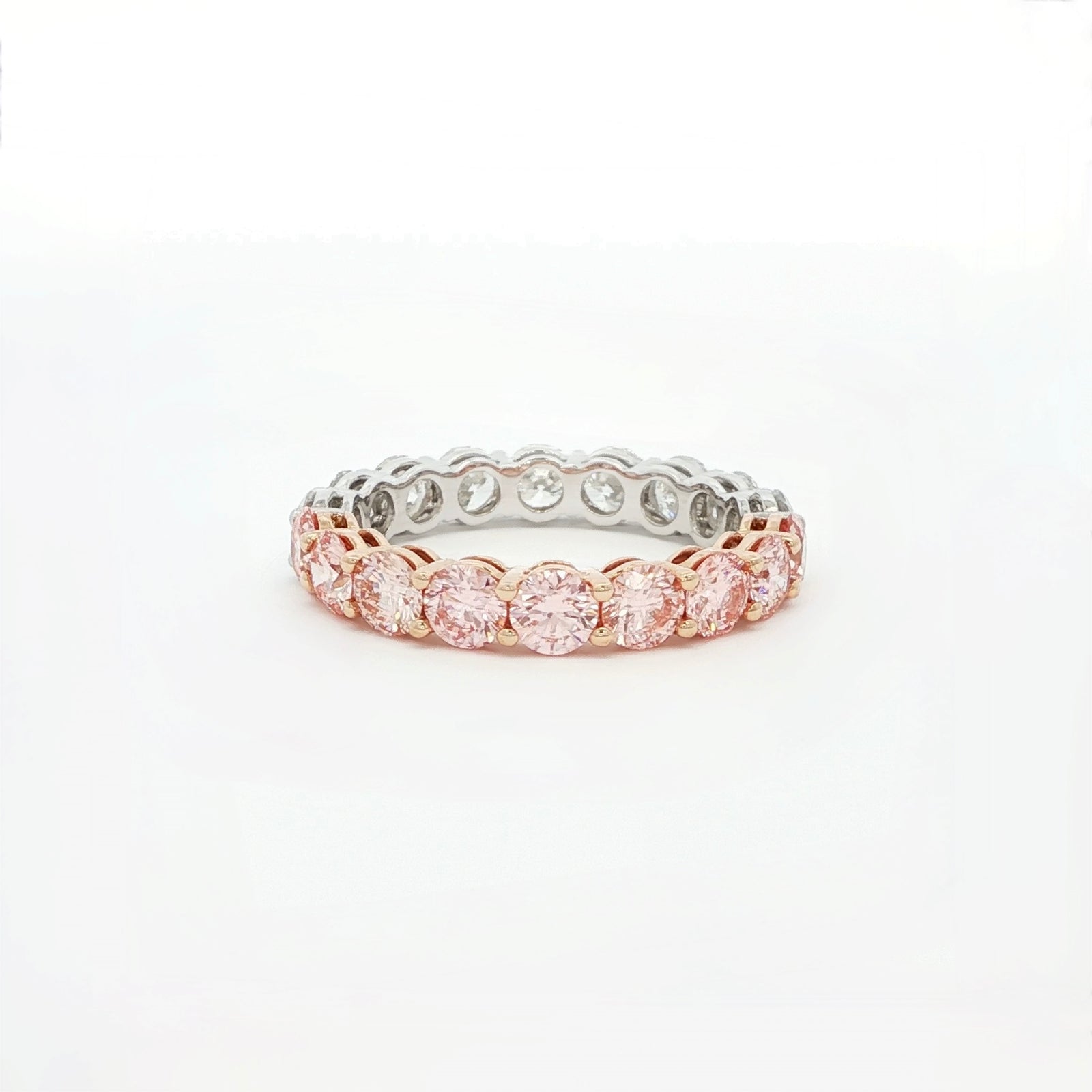 Two-tone ring with pink and silver stones on a white background