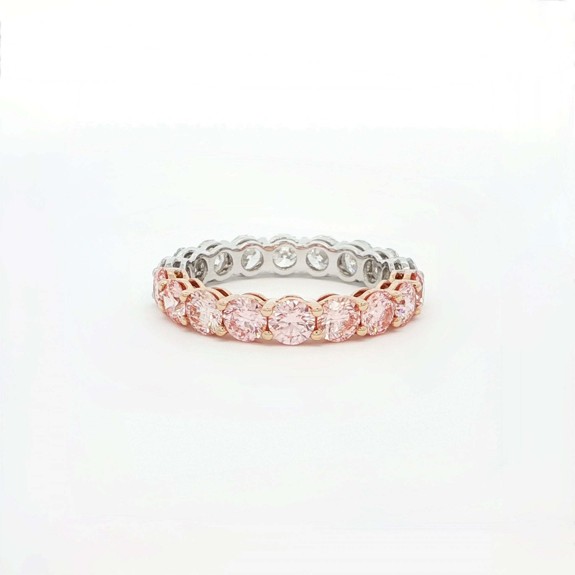 Two-tone ring with pink and silver stones on a white background