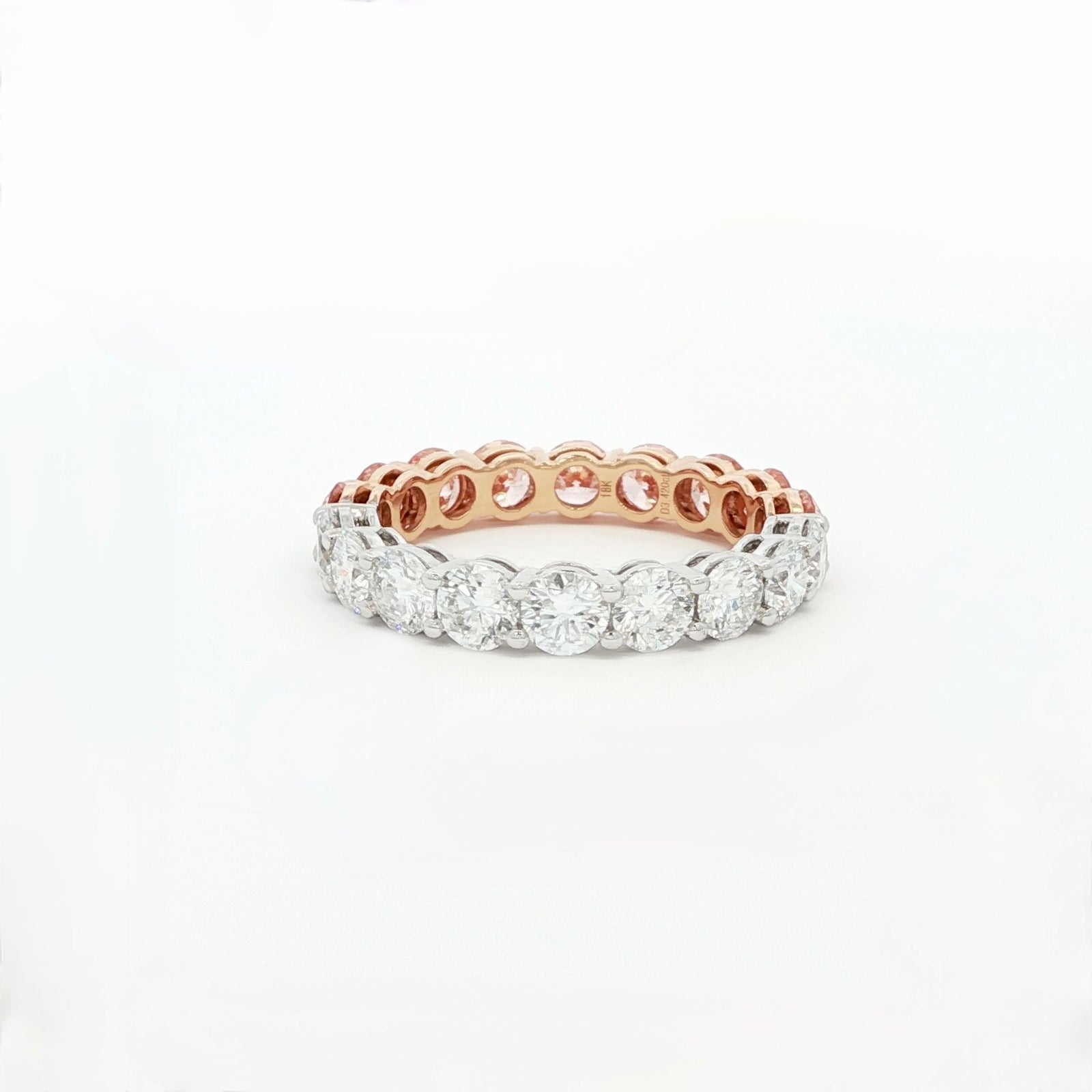 Rose gold and silver ring with diamonds on a white background