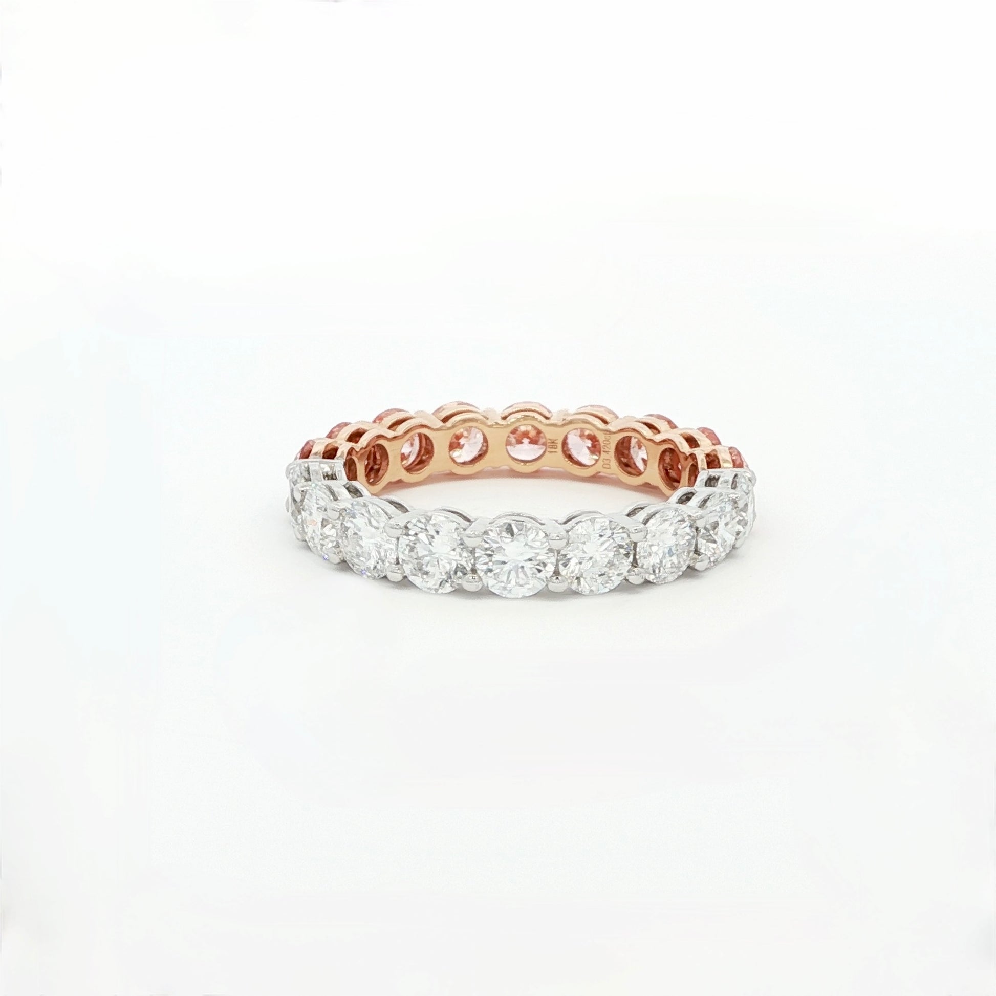Rose gold and silver ring with diamonds on a white background