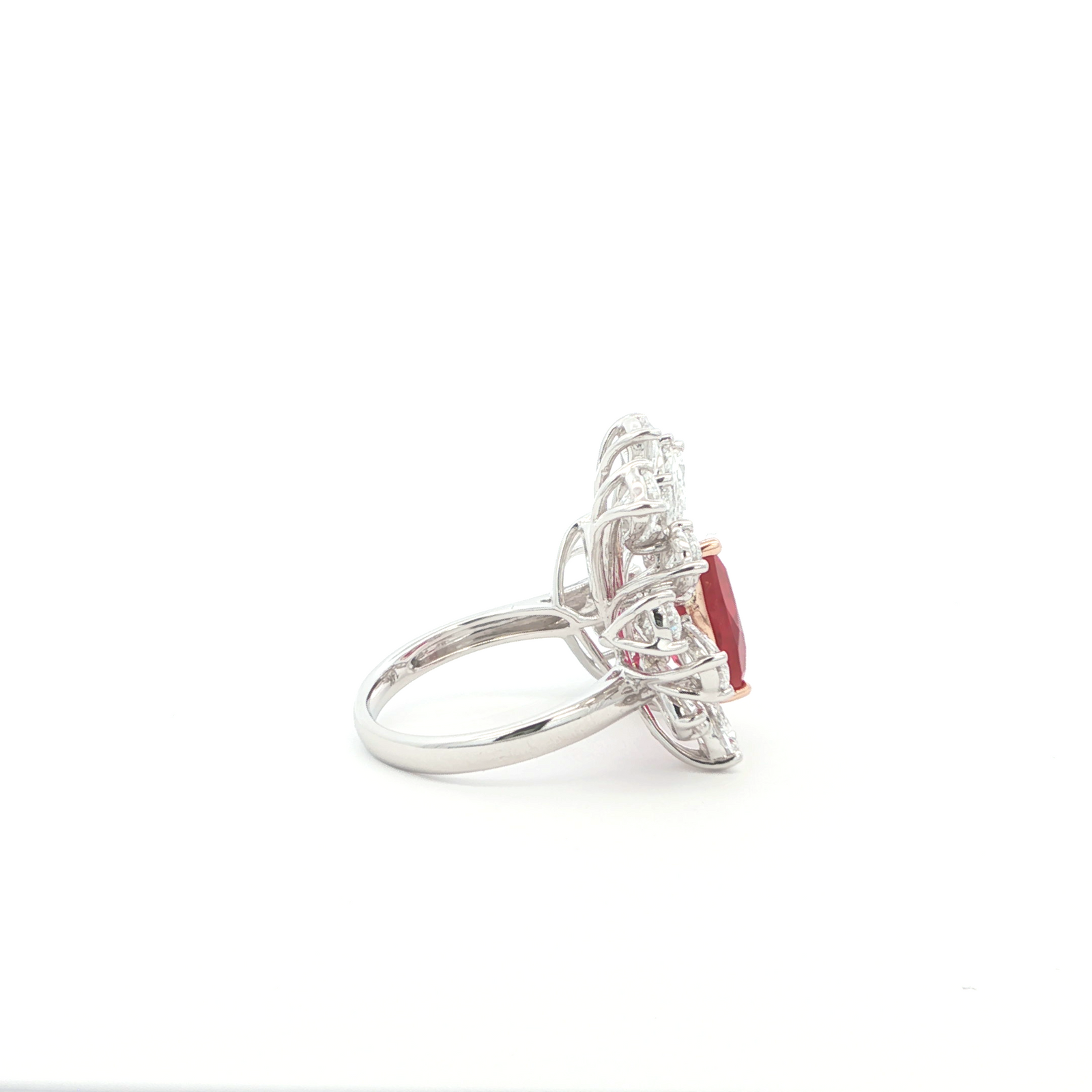 Lab grown ruby ring with clusters of marquise and pear diamonds in an open style setting. Set in a unique and luxurious combination of 14K White and Rose Gold.