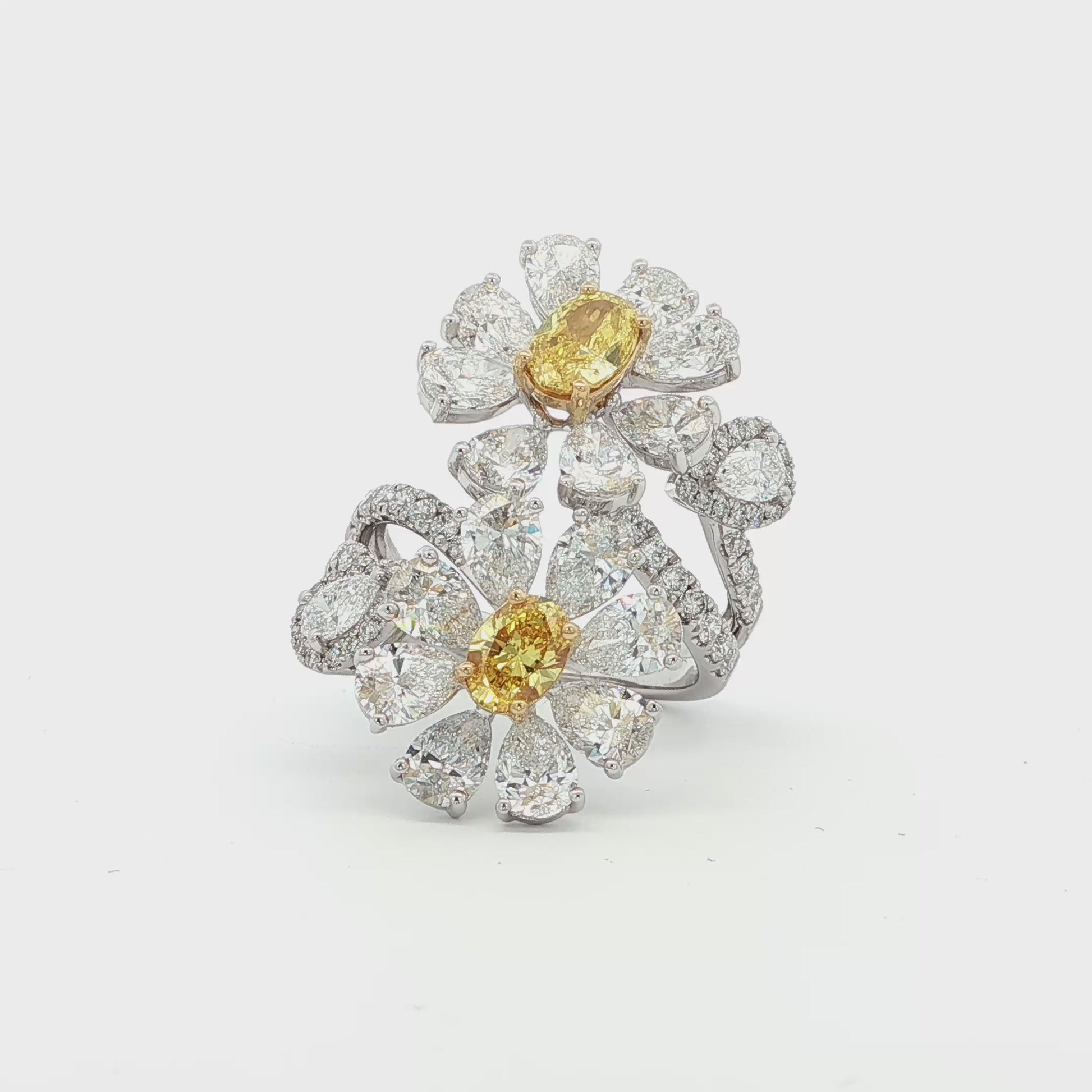 18K_White_Gold_Floral_Lab_Grown_Diamond_Ring_Fancy_Yellow_Cocktail_Everyday_Evening

This 18K White Gold ring features a floral-inspired design with two oval-cut fancy yellow diamonds, expertly cut in a brilliant style. These radiant gems are accented by white diamond "petals"; creating a stunning contrast and adding to the ring's overall charm and opulence. A true statement piece for any special occasion!