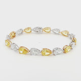 18K White and Yellow Gold Duo-Tone Pear-Cut Lab-Grown Diamond Bracelet

A bold, duo-tone bracelet that showcases Pear-cut diamonds in an alternating pattern of white and yellow stones. Each diamond is securely held in place by a refined three-prong design, with white diamonds set in white gold and yellow stones in yellow gold. Crafted in a sophisticated combination of 18K White and Yellow Gold, this bracelet offers modern luxury for any occasion.