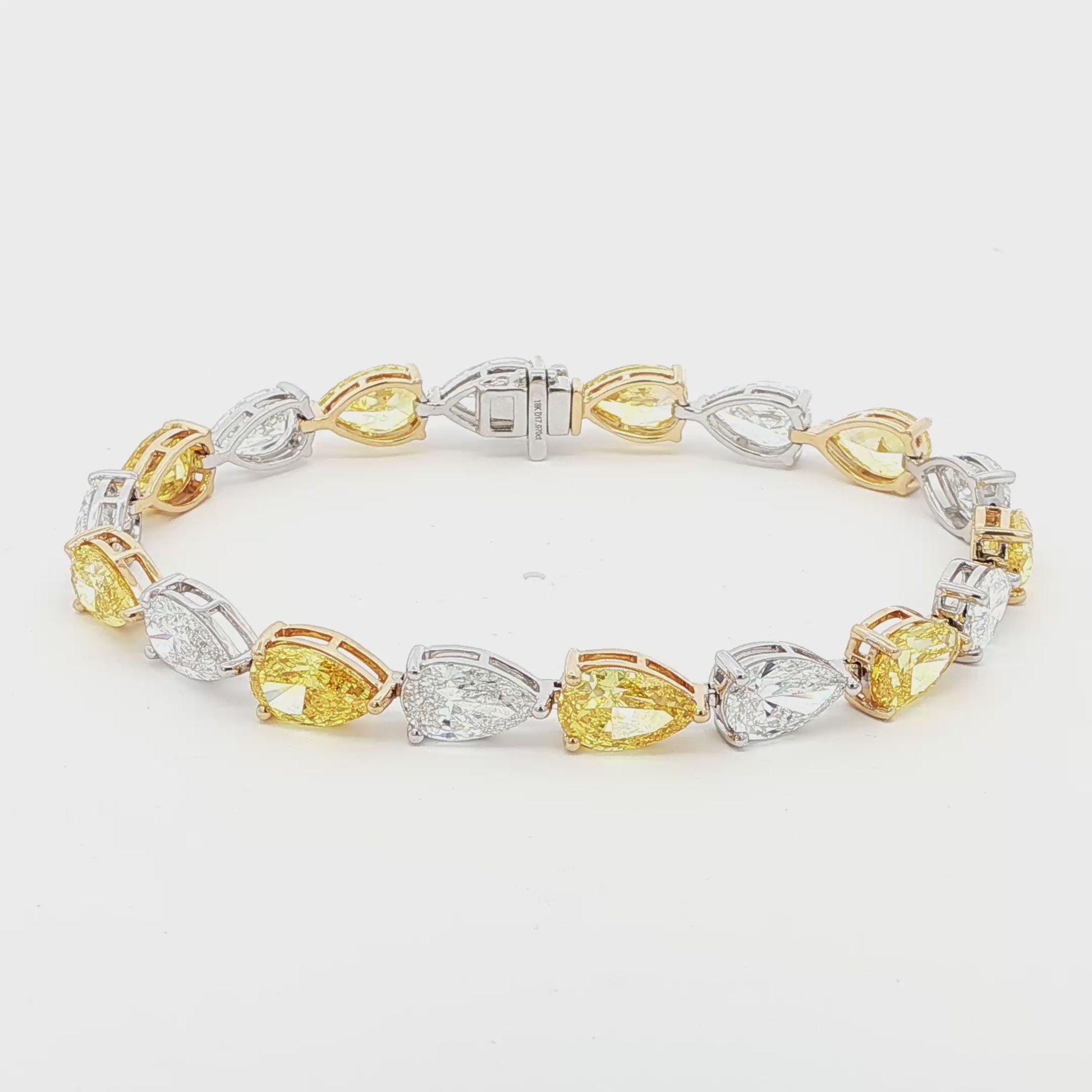 18K White and Yellow Gold Duo-Tone Pear-Cut Lab-Grown Diamond Bracelet

A bold, duo-tone bracelet that showcases Pear-cut diamonds in an alternating pattern of white and yellow stones. Each diamond is securely held in place by a refined three-prong design, with white diamonds set in white gold and yellow stones in yellow gold. Crafted in a sophisticated combination of 18K White and Yellow Gold, this bracelet offers modern luxury for any occasion.