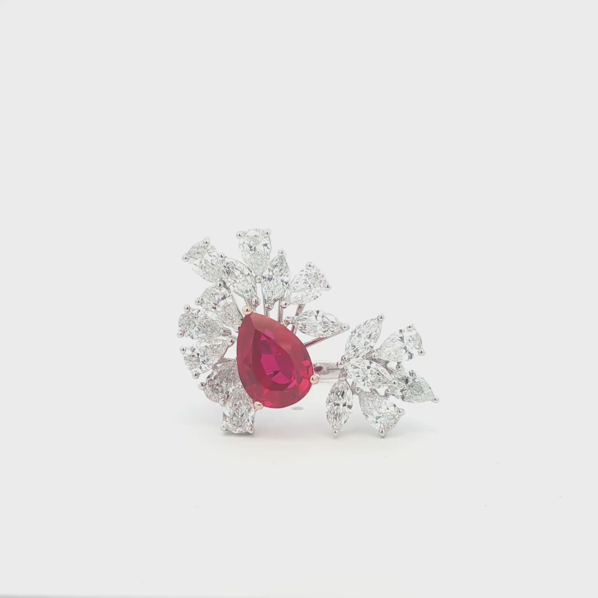Lab grown ruby ring with clusters of marquise and pear diamonds in an open style setting. Set in a unique and luxurious combination of 14K White and Rose Gold. 