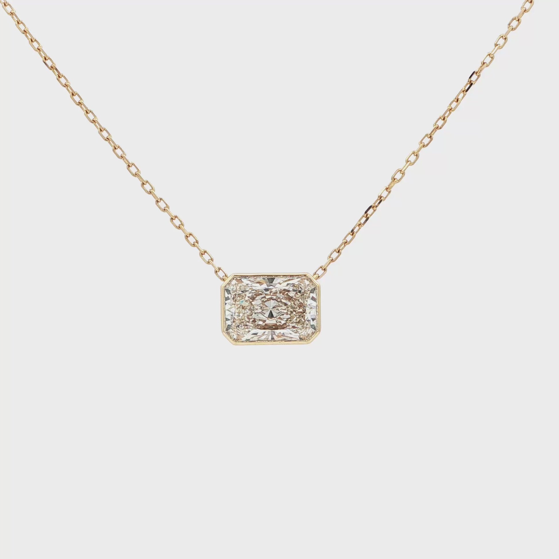 Lab-grown radiant-cut diamond pendant necklace in 18k yellow gold, bezel set. 