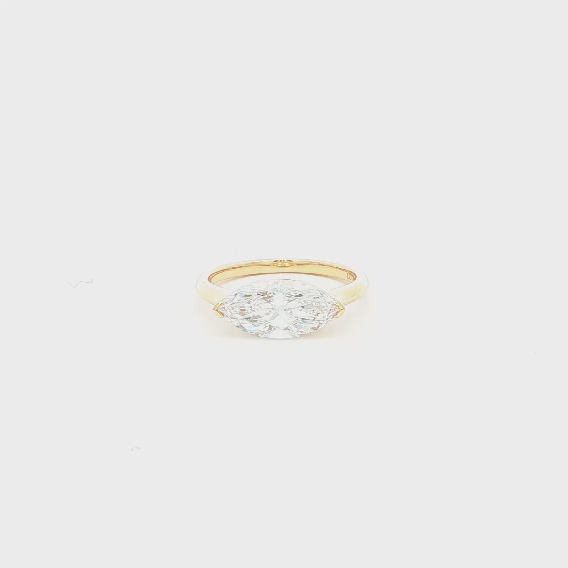 Marquise lab-grown diamond, east-west setting, half bezel in 18k yellow gold. 
