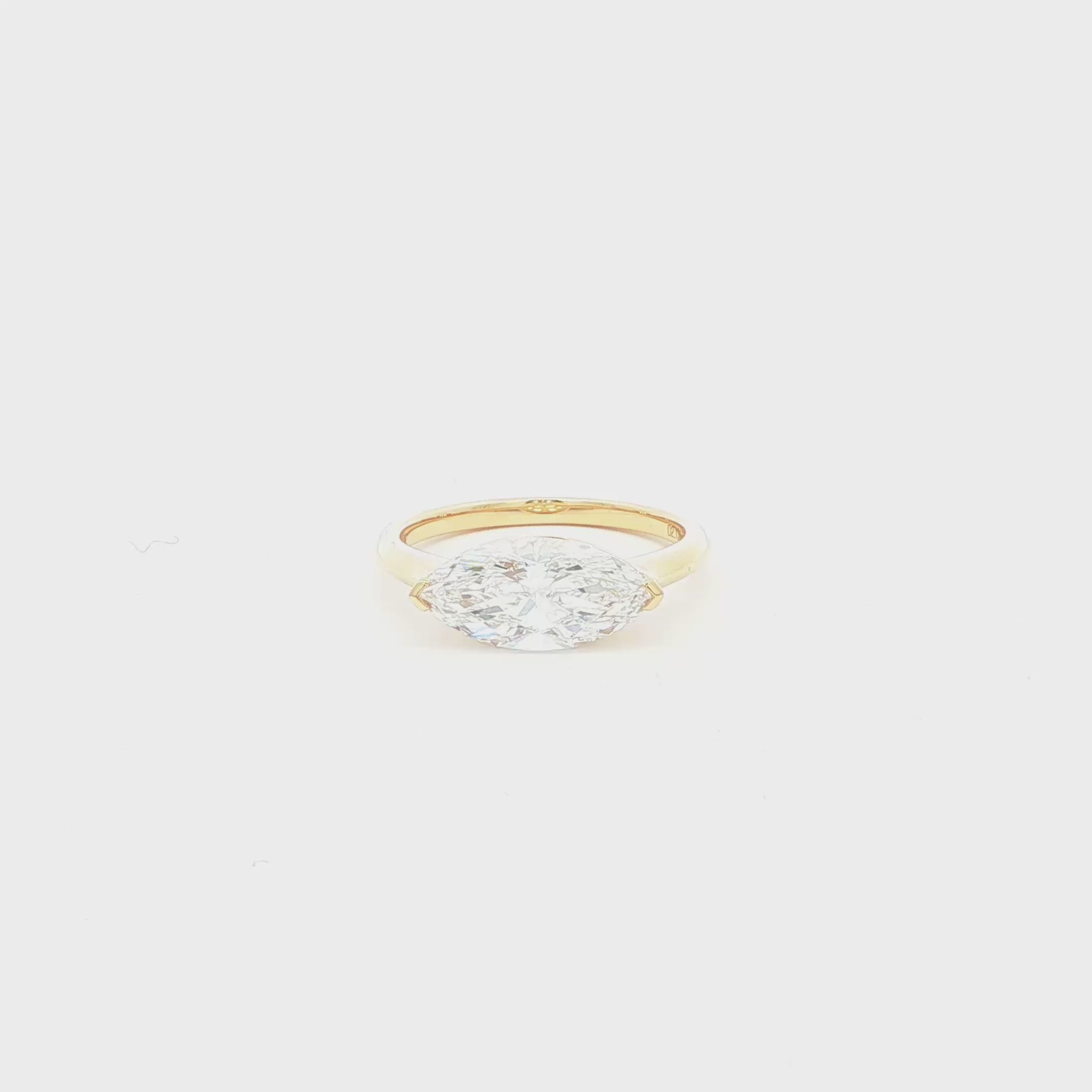 Marquise lab-grown diamond, east-west setting, half bezel in 18k yellow gold. 