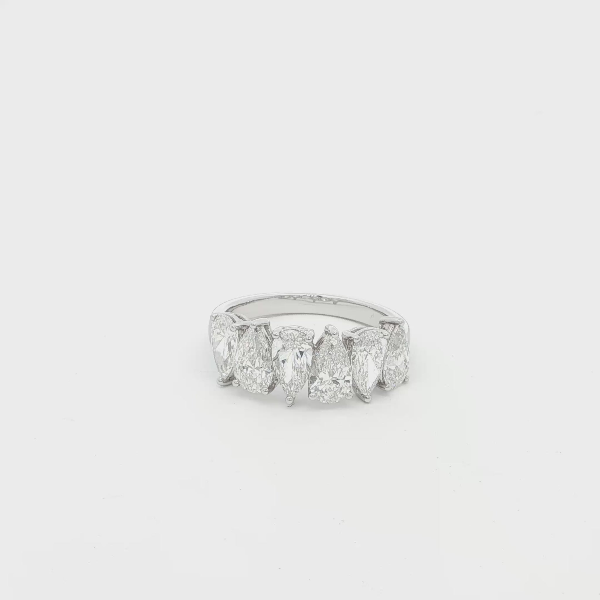Pear cut lab grown diamond ring in half eternity style, 18k white gold.
